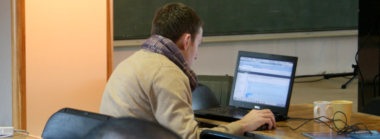 A man coding at a programming camp