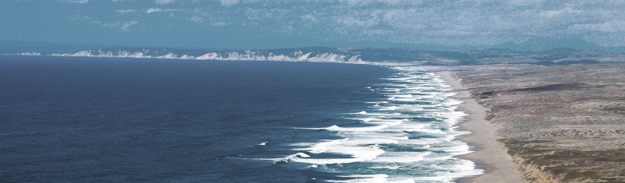 Ocean waves, extensive beach, and shrublands