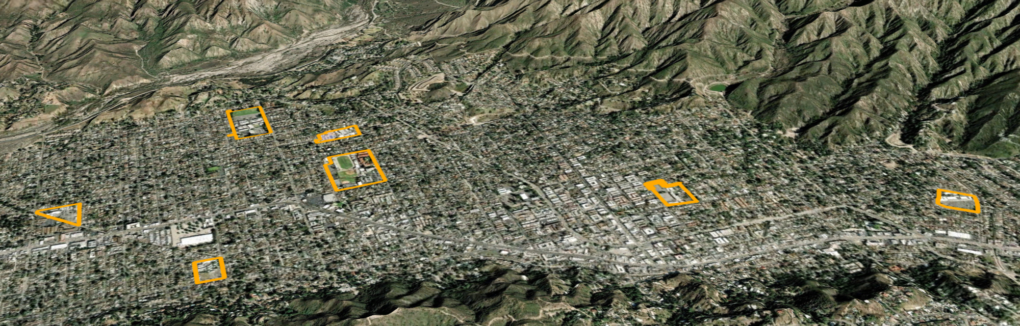 Aerial view of a city with multiple school campuses outlined in thick borders.